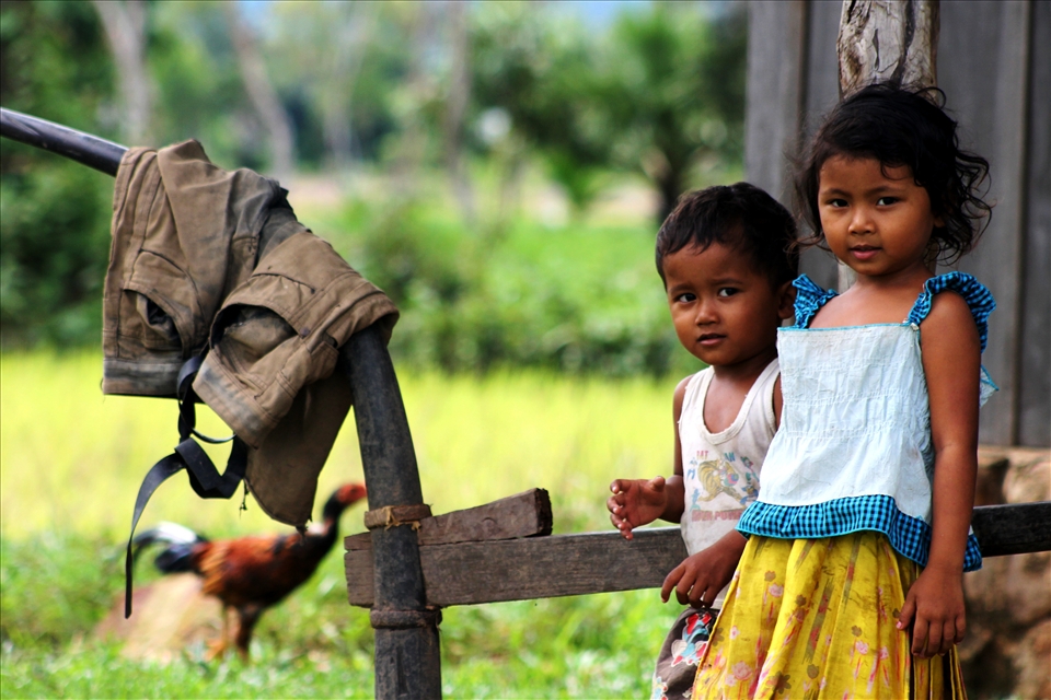 'home' - taken in the rural town of Kampot, South Cambodia. I was once again on my bike, cycling through the rice fields and noticed a brother and sister playing in front of their home. The moment captures their curiosity in me as much as them, in the setting of a normal day at home.