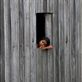 'thoughts' - taken in the small rural town of Kampot, South Cambodia. A young girl seems far away in thought, resting, looking out her home window into the rice fields. What is she thinking of...?: by oneglassglobe, Views[459]