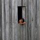 'thoughts' - taken in the small rural town of Kampot, South Cambodia. A young girl seems far away in thought, resting, looking out her home window into the rice fields. What is she thinking of...? Views[378]