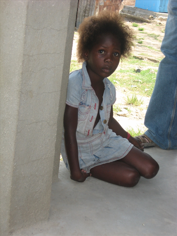 Beautiful little girl living in the batey close to the fields. 
She sat quietly next to the group of tourists to listen to the conversations. Her eyes were sad and meaningful, and her attitude timid but assertive. She seemed to know so much, yet eager to learn even more.