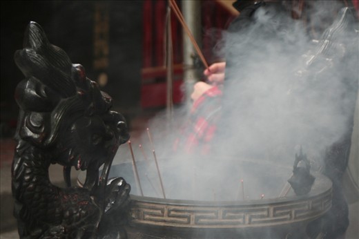 The sticks disappear in the big smokey cauldrons spread out over the temple