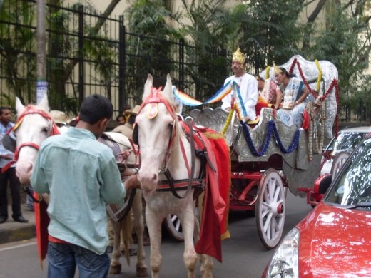 Traffic jam Bangalore style. car tried to overtake wedding (?) procession and came of worst.