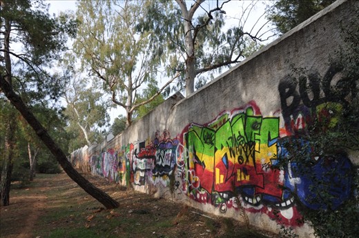 Graffiti in Athens is as old as the city itself. This wall covered with maddening signatures and art-designs separates the forest park and Athens College (Kollegio Psychico). I live a minute walk from this park.