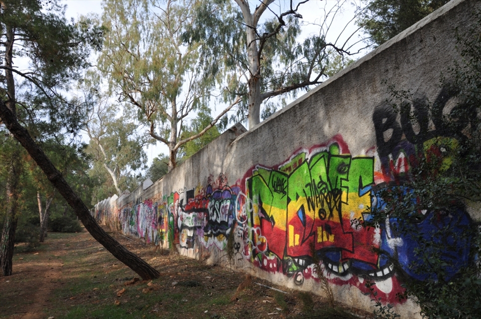 Graffiti in Athens is as old as the city itself. This wall covered with maddening signatures and art-designs separates the forest park and Athens College (Kollegio Psychico). I live a minute walk from this park.