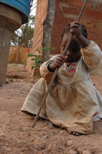 Esperanza, daughter of our cook, playing with her toy