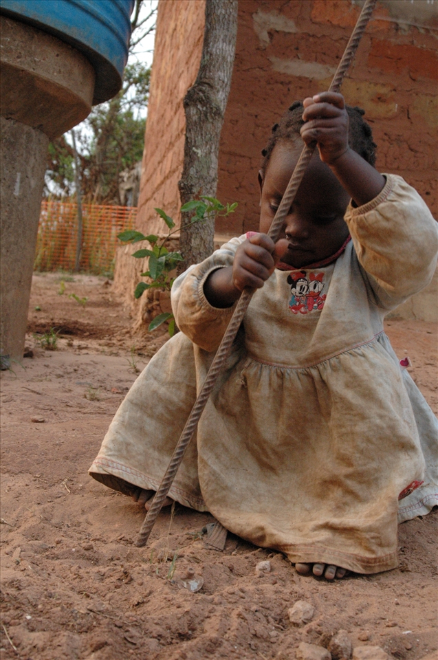 Esperanza, daughter of our cook, playing with her toy