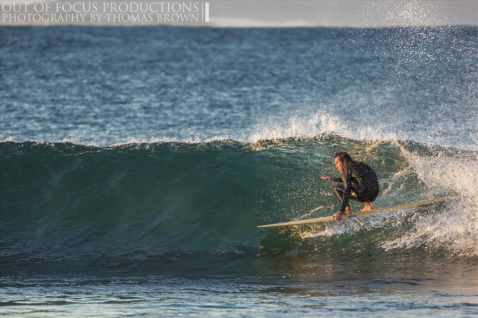 Andy Finlay on his traditional Single fin long board racing a fast section.