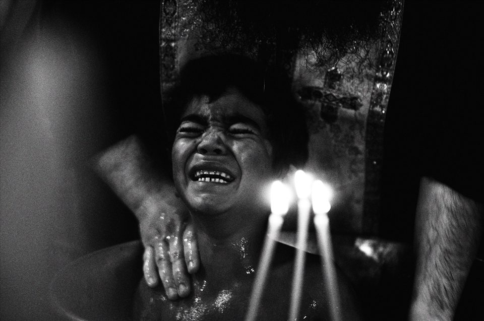 A young boy is being baptized