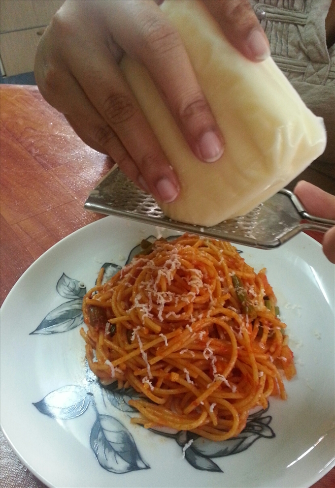 Topping it up with grated mozzarella