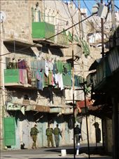 Armed Israeli soldiers walking through deserted Shuhada Street in Hebron, where the old Arab shops remain permanently closed.: by palestine, Views[396]