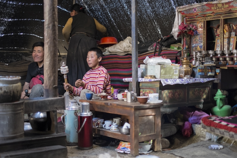 Inside the woolen tent anticipation of dinner is in the air. Father has left yaks high up in the mountains for a day. He spends time with Karma’s younger brother who is spinning his prayer drum in the puja corner. His son joined a monastery as a student and will be leaving the household soon as well.