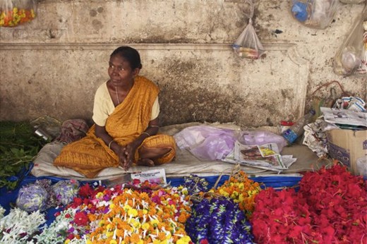 A woman sells garlands at  Kolkata's flower markets