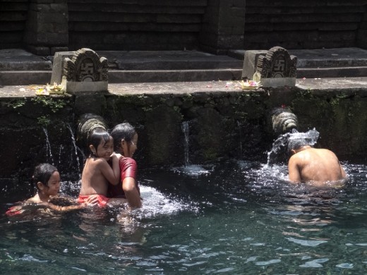A local family bathes in the holy spring