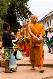 A young boy begs for food from a passing Buddhist monk.: by paulfilm, Views[402]