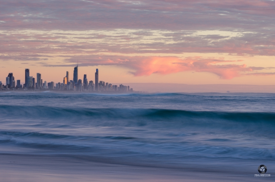 A calming moment in time to take in the early morning sunrise. I frantically tried to get down to the waters edge and into position to capture this one as heavy clouds swept across the city skyscrapers of Surfers Paradise in the background.