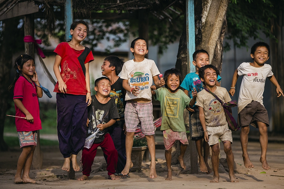 Innocent Village kids from the Golden Triangle Region bordering Laos, Bhurma, and Thailand. 

The kids benefit from the tourism, while illicit drug trade is happening unseemly all around the them. 