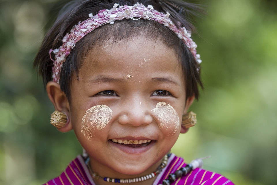 Tribal girl with traditional markings and piercings. 

There are many villages in the mountains of Northern Thailand. Each village with their own traditions and clothing and languages. Many customs and traditions are lost through  westernisation and exploits of tourism. 