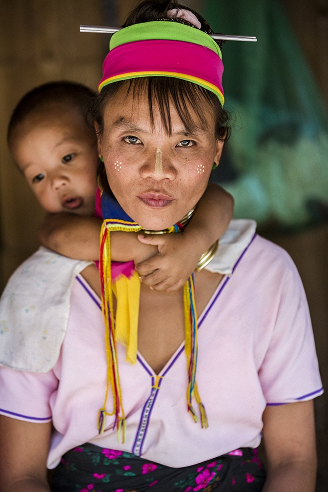 Mother and Son of Karen Long Neck Hill Tribe

The mother is not happy when her son appears from the hut behind her. This is because only the girls wear the long neck rings, and the boys are not wanted in tourist photos...
