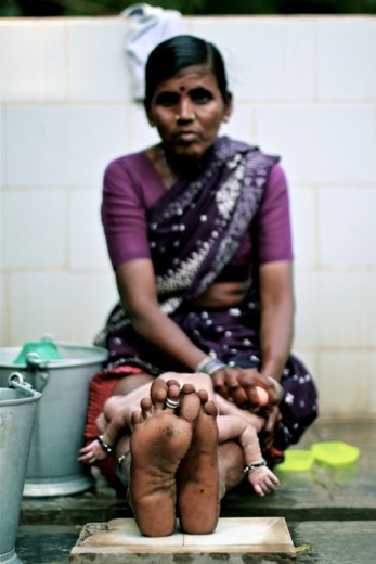 Woman bathing her grandson at RDT Maternity Center, Anantapur (Andhra Pradesh).