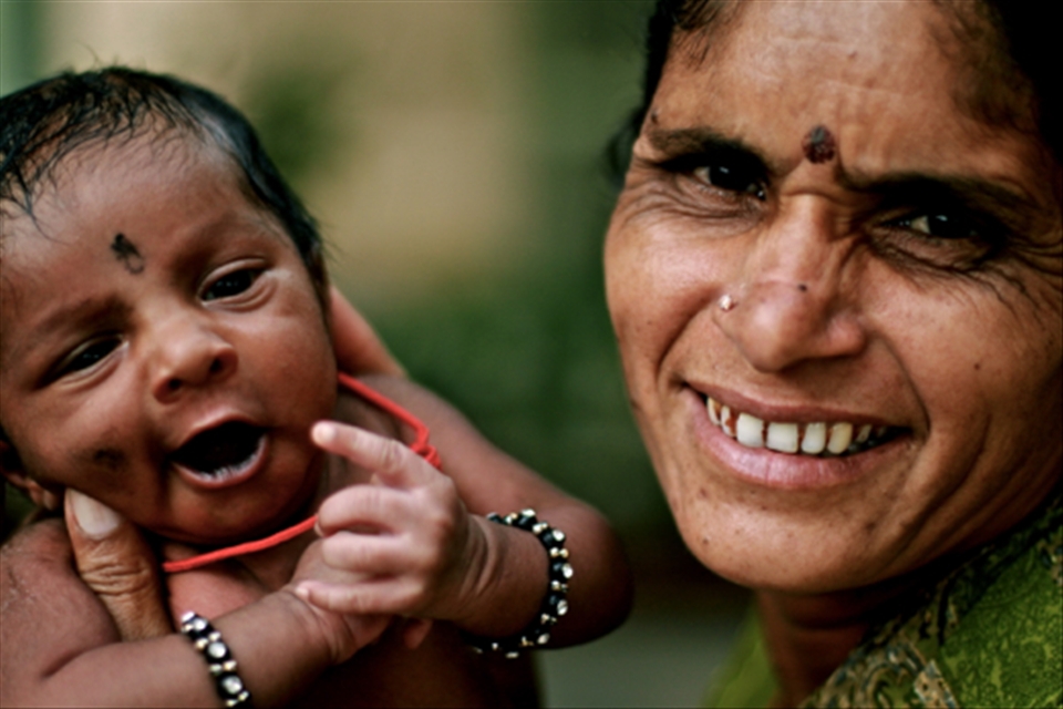 Woman posing with her grandson.