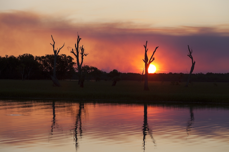 Fire and smoke from controlled burning and Land Management during the dry season within Kakadu National Park add to the intensity, colour and drama of this sunset at Yellow Waters, Cooinda.
