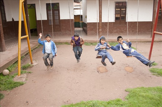 As the rain ceases on yet another rainy Cusco day, the boys run for the swings. 