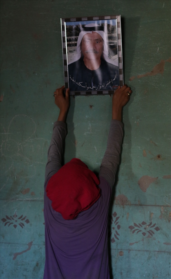 Safaa holds her grandfather's picture.