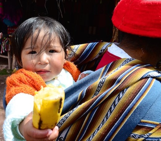 Baby offering banana
