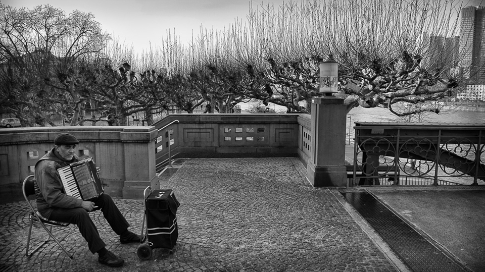 While walking in the cold -8 degree a man dreams at the end of the bridge.