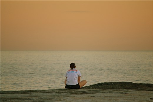 A woman taking in a sunset after she finished her run.