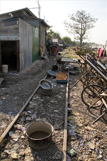 There are no fancy kitchens in this house, the family makes do with a few bowls and woks beside disused train tracks to prepare their meals and clean their belongings. 