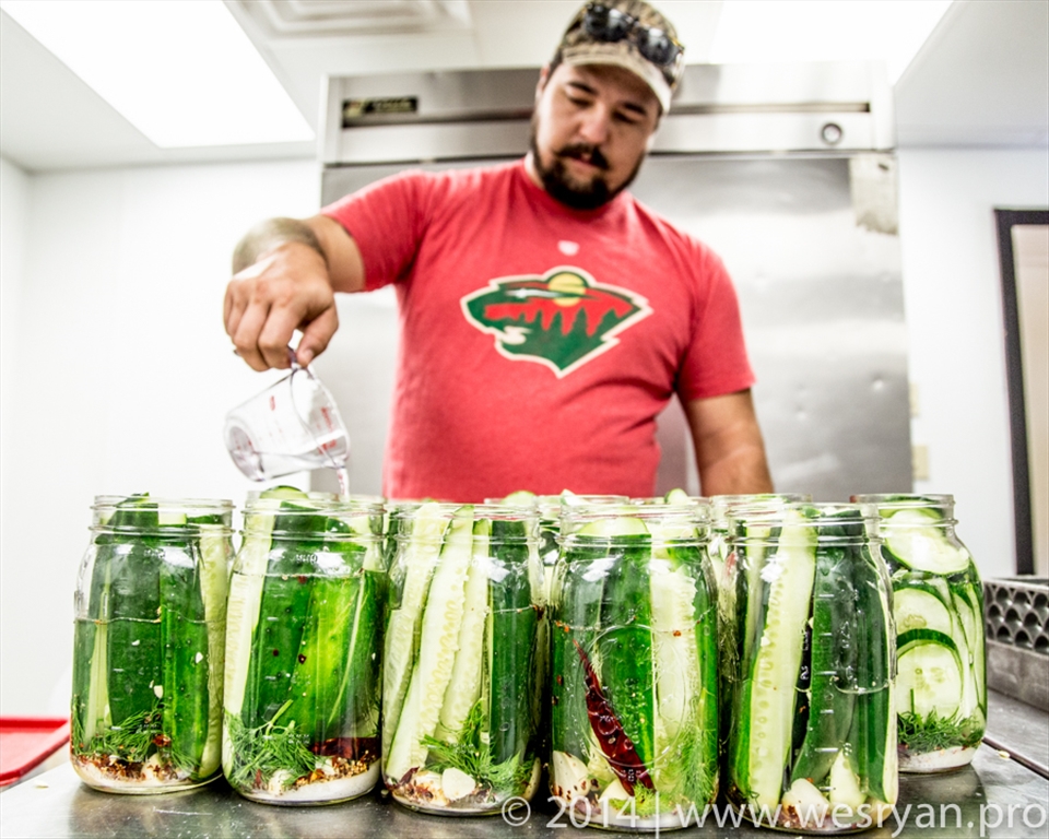 Garret Gunderson of Fayetteville, AR in the canning process of making pickles.