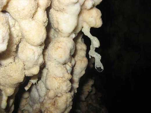 the snow like form in the cave with drops of mineral