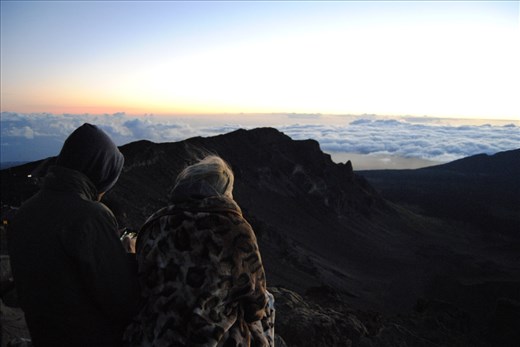 Haleakalā Sunrise is one of the experiences that every local and visitor to Maui must achieve.
Lovers, family and acquaintances who recently became friends start ascending a few hours after midnight, to arrive to the highest peak of the island, at 10.023 feet (3.055 meters), and sit on the 
crater rim, awaiting for the Sun to shine bright in front of their eyes.

Curiosities to those who are familiar, especially with higher volcanoes: you can drive to the top of Haleakalā, and practically just walk a few meters to be at its peak... where you also have reception to check the time at which the sun will come up!