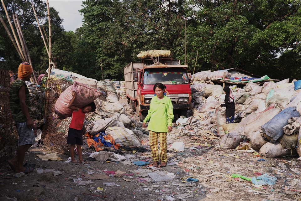 People of all ages & genders scour tons of trash for items to re-sell and reuse