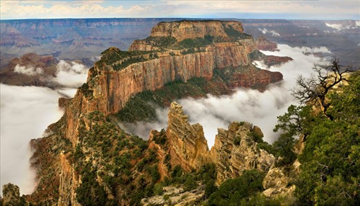 Summer monsoon clouds wrap around Wotans Throne on Grand Canyons North Rim