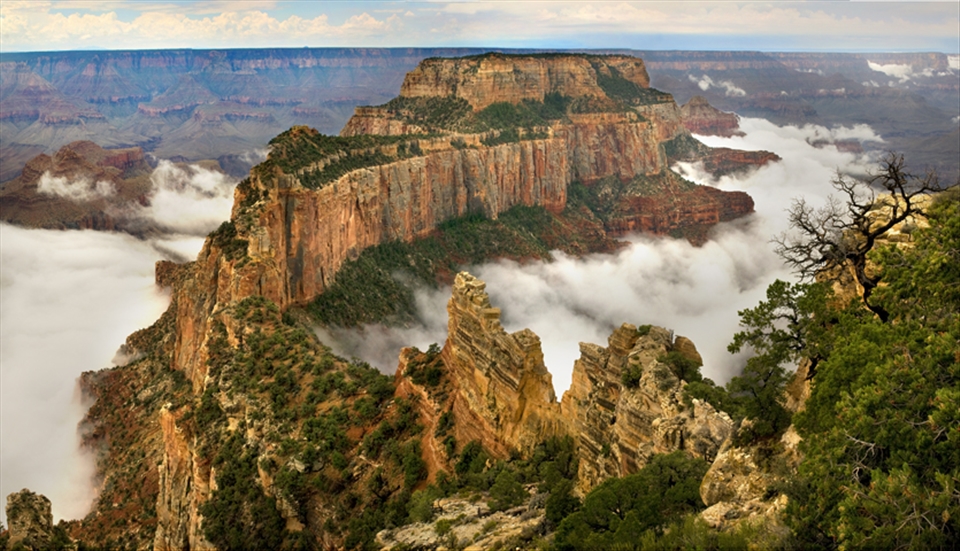 Summer monsoon clouds wrap around Wotans Throne on Grand Canyons North Rim