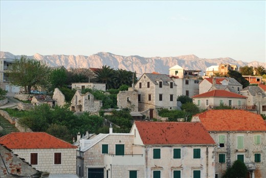 Illuminated hills beyond the village of Sumartin, Island Brač. The houses are build in the traditional dalmatian style. The village looks like the time has stopped.