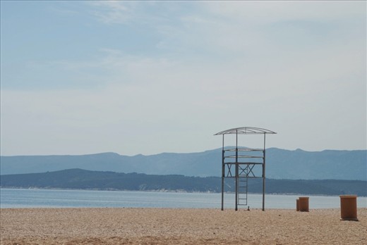 The lifeguard stand and trash bins are waiting for the crowds to roll in.