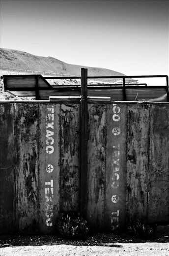 Some empty barrels of Texaco fuel found their final spot in a handmade fence. Deserts are described usually as thousand acres of dry, harsh land where the plain stretches right to the horizon, but one thing is undeniable… people have adapted to life in the desert for many, many years. After decades without any rainfall, abandoned towns like Machuca are used to a tough kind of life and if nature is kind they will endure. 