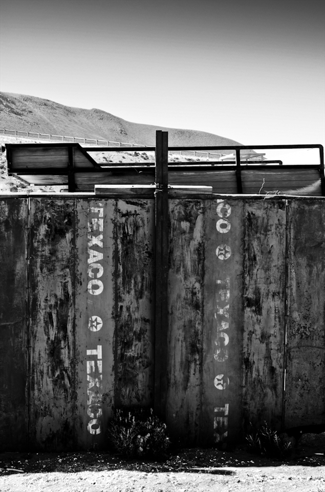 Some empty barrels of Texaco fuel found their final spot in a handmade fence. Deserts are described usually as thousand acres of dry, harsh land where the plain stretches right to the horizon, but one thing is undeniable… people have adapted to life in the desert for many, many years. After decades without any rainfall, abandoned towns like Machuca are used to a tough kind of life and if nature is kind they will endure. 