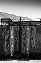 Some empty barrels of Texaco fuel found their final spot in a handmade fence. Deserts are described usually as thousand acres of dry, harsh land where the plain stretches right to the horizon, but one thing is undeniable… people have adapted to life in the desert for many, many years. After decades without any rainfall, abandoned towns like Machuca are used to a tough kind of life and if nature is kind they will endure. : by photonomy, Views[541]