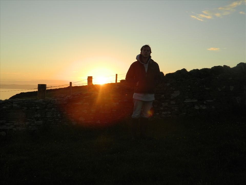 Local Jo admiring the sun from behind the dry stone dyke.