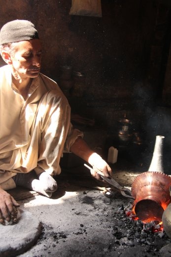 Srinigar market - making copperware