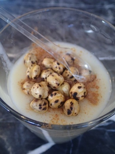 A glass of hot boza with roasted chickpeas