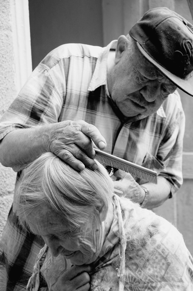 My grandparents just have each other, and rely only on each other in all daily tasks. This typical hairdressing scenario is a tender yet utilitarian moment between the two. My grandfather is by no means a hairdresser and the resulting hairstyle is usually haphazard and ragged. This shot was taken as my grandmother was giggling and telling him not to clip her neck or ear again. 