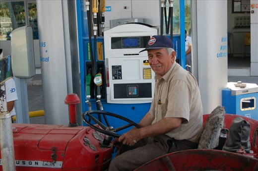 Farmer filling tractor at service station
