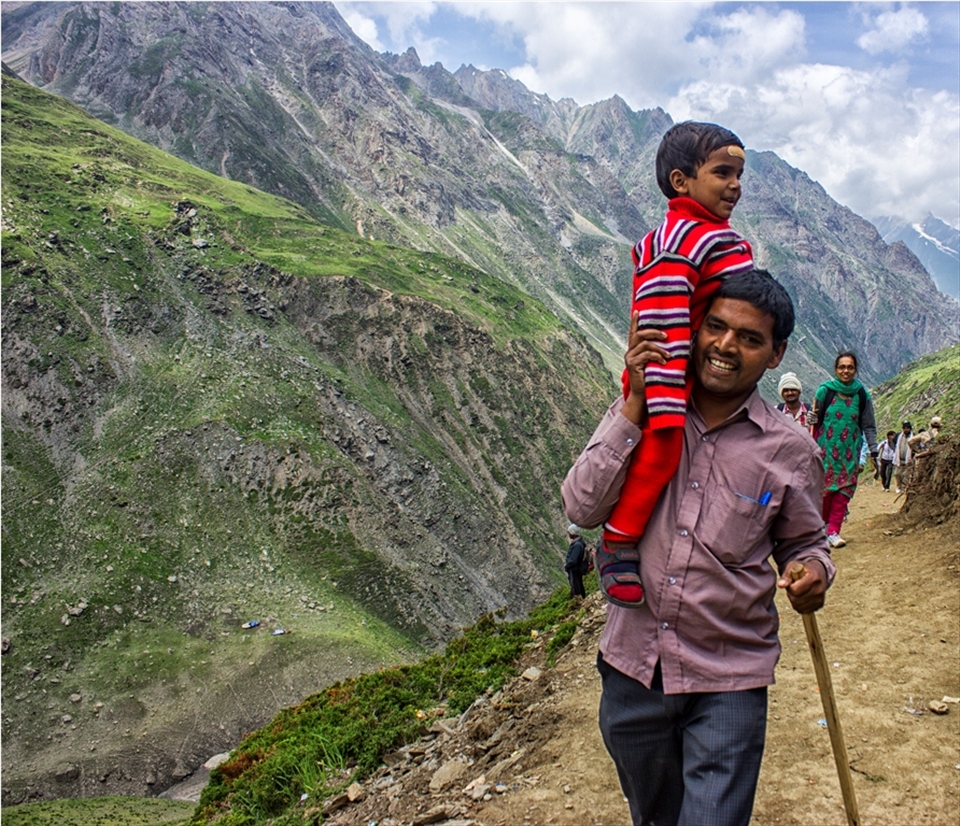 A Pilgrim and his child during the track of Amarnath .