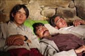 Three friends relax together in a shelter on the Baltoro glacier. Away from their families for weeks at a time, the men sleep in crude stone shelters with plastic sheeting for a ceiling, sleeping huddled together under old sleeping backs for warmth.: by portering, Views[1808]