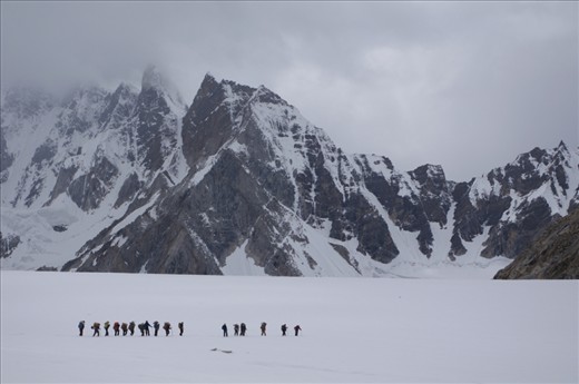 BALTISTAN, northwest Pakistan: Porters crossing the Upper Baltoro glacier. Trekkers and climbers come from across the world to this isolated corner of the globe to experience some of the highest mountains in the world. To access this remote region requires porters to carry supplies. The local men are eager for a source of income as portering is one of the few alternatives to a life of subsistence agriculture.